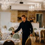 man in black long sleeve shirt pouring wine