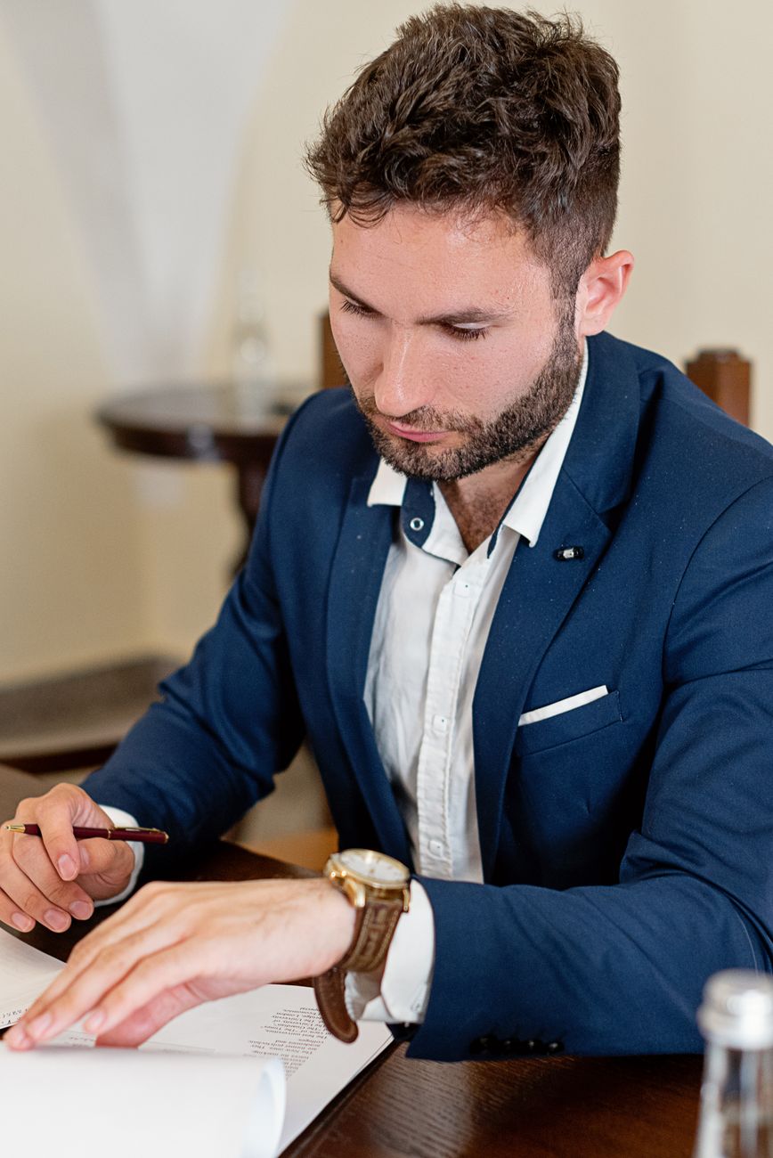 a man in a suit reading a document